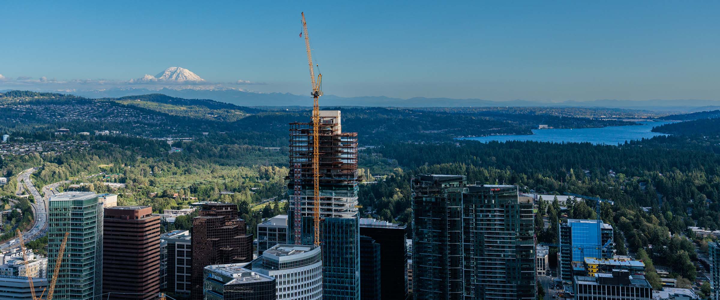 Aerial view of 555 Tower under construction with Mt Rainier in the background