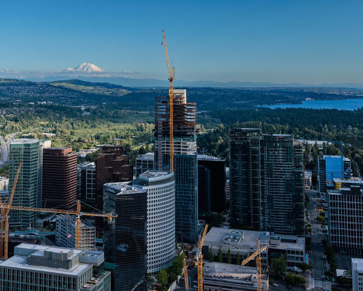 Aerial view of 555 Tower under construction with Mt Rainier in the background
