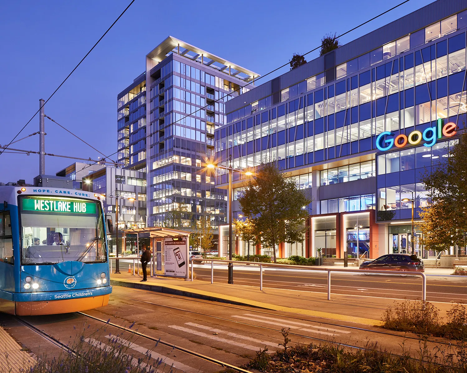 google building at night with light rail